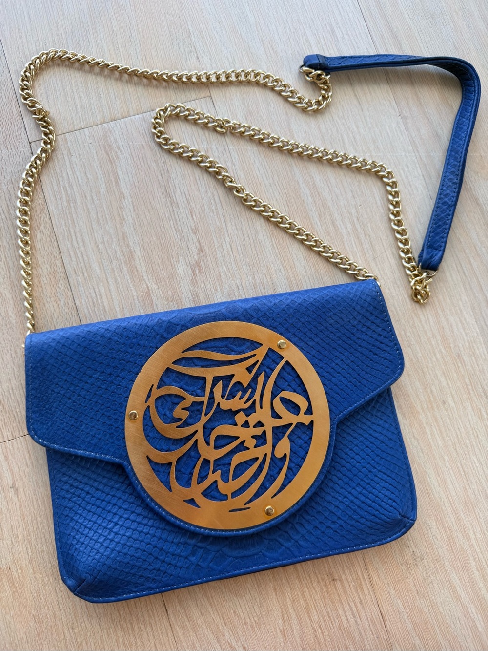 Dareen Hakim Blue Crossbody Bag with Decorative Gold Medallion